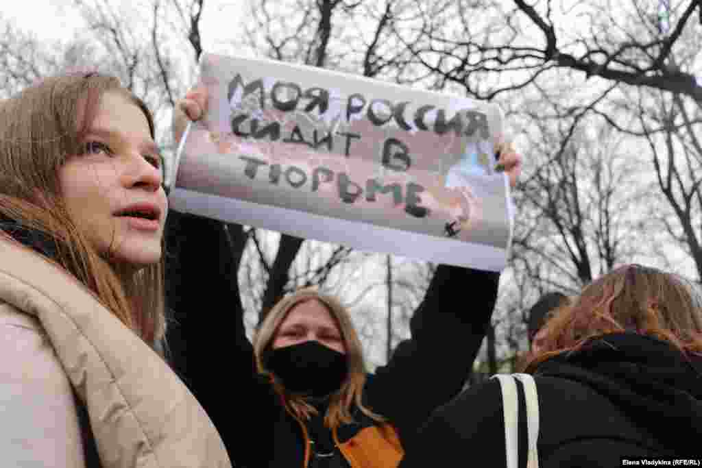 A demonstrator in St. Petersburg holds a sign reading: "My Russia Is In Prison."