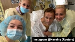 Russian opposition leader Aleksei Navalny poses with family members at Charite hospital in Berlin in September, shortly after he was brought out of an induced coma for Novichok poisoning.