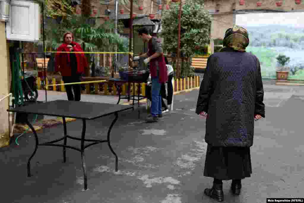 მოქალაქეები სათითაოდ შედიან "კათარზისის" ეზოში, რათა დაიცვან დისტანცია.