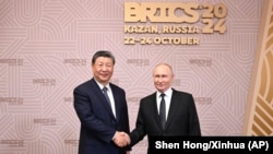 Chinese leader Xi Jinping (left) and Russian President Vladimir Putin meet in Kazan, Russia, for the 2024 BRICS summit. 