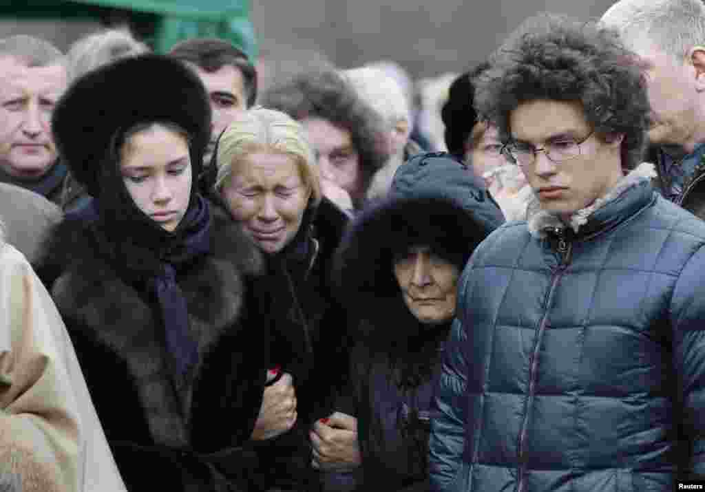 Nemtsov's former partner, Yekaterina Odintsova (second from left), their children Anton (right) and Dina, and Nemtsov's mother, Dina Eidman (second from right), attend the funeral.