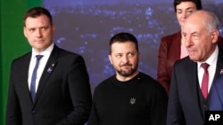 Ukrainian President Volodymyr Zelenskyy looks toward Hungarian President Tamas Sulyok during a group photo at a summit in Lithuania in April 2024.