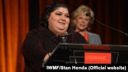 Khadija Ismayilova accepts the 2012 Courage in Journalism award from the International Women's Media Foundation in New York in October 2012.