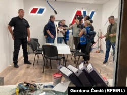 Serbian President Aleksandar Vucic visits the damaged premises of the ruling Serbian Progressive Party on August 18.