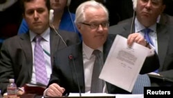 Посол Росії в ООН Віталій Чуркін на засіданні Ради безпеки ООН демонструє листа екс-президента України Віктора Януковича до керівника Росії Володимира Путіна з проханням використати військо для відновлення «законності і правопорядку в Україні». Нью-Йорк, 3 березня 2014 року 