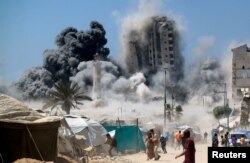 Qəzza şəhərində İsrailin hava hücumundan çökən bina.