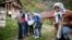 Bosnian Muslims speak with a survey taker during Bosnia's first census in the village Krusev Do, near Srebrenica, in October 2013.