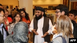 Suhhail Shaheen, spokesman for the Taliban in Qatar, talks to journalists during the Intra-Afghan dialogue on July 8.