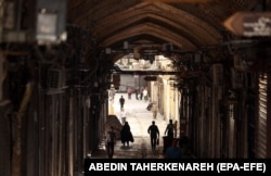 People walking past closed shops in Tehran’s Grand Bazaar on June 16.