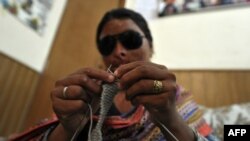 Naziran, 25, an acid victim, knits at a rehabilitation center of the Acid Survivors Foundation in Islamabad.
